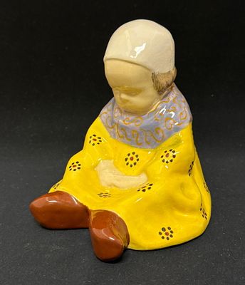 French Faience Figurine. HB Quimper Berthe Savigny seated jeune fille with folded hands 