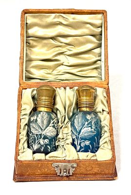 Box Set of Victorian Perfumes. Two blue perfumes with white flowers and gold washed flip tops 