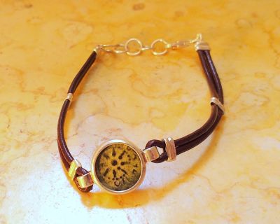 Leather bracelet with original "Widow's Mite" coin, 103-76 B.C.E. From archaeological 