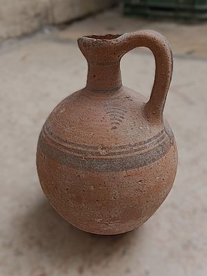 קנקן חרס. Ceramic jug, with single lug handle and trefoil rim; burnished slip; linear 