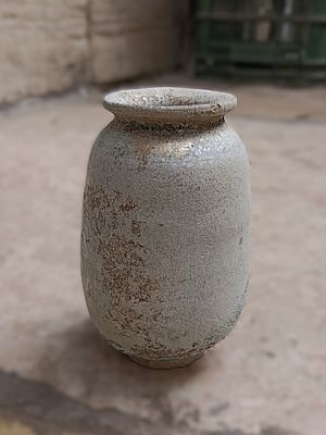 סיר חרס. Ceramic pot with everted rim; body widens towards the ring base; greenish white glaze; 