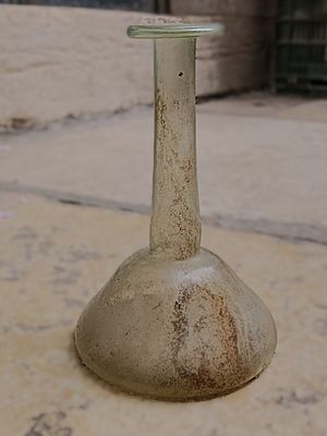 כלי זכוכית עתיקה. Tear glass with long neck with flat rim folded downwards; wide shallow body 