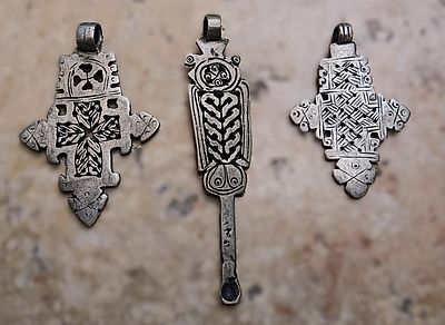 Group of three low silver Ethiopian Coptic pendants, 2 crosses, 6.6 x 4.5 and 5.7 x 3.75 cm; 