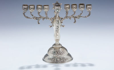 A Silver Hanukkah Menorah. A SILVER HANUKKAH MENORAH. Germany, c. 1890. On round base, decorated 