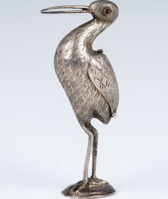 A SILVER CONTAINER. Dutch, early 20th century. In the shape of a stork on a round base. Garnet 