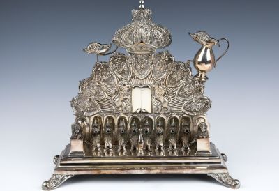 A LARGE STERLING SILVER HANUKKAH LAMP. Probably American, c. 1970. On four baroque feet. With 