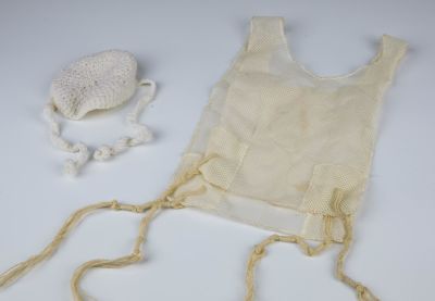 A PAIR OF TZIZIT AND KNITTED KIPPAH FOR A BRIS MILAH. Probably American, 20th century. The 