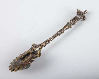 22. A BRASS MATZAH POKER. Eastern Europe, c. 1900.. A rolling piercer for matzah with a figural 