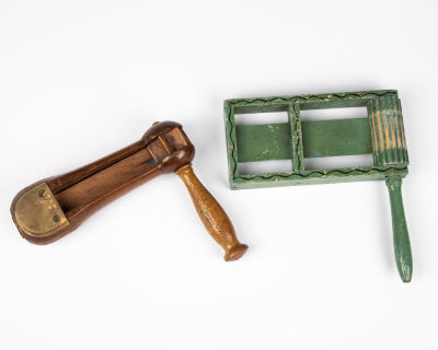 31. TWO VINTAGE PURIM GRAGGERS. Probably American, c. 1900. On painted green and one in natural 
