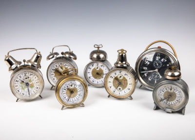 33. A COLLECTION OF SEVEN HEBREW DIAL ALARM CLOCKS. Various sizes and origins, 20th century. 