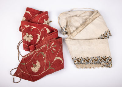 35. TWO EMBROIDERED TORAH WIMPLES. Germany, 19th century. On with Hebrew embroidery with a name.
