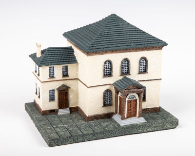 43. A RESIN CHARITY BOX IN THE SHAPE OF THE TOURO SYNAGOGUE. Probably American, c. 1980. 6” long.