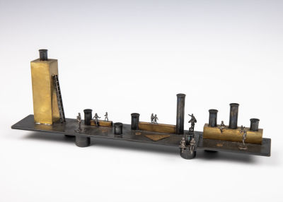 46. A HANDMADE MENORAH BY WINGED CAMEL. Twentieth century. In arts and crafts form. 12” long.