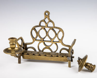 50. A BRASS HANUKKAH LAMP. Poland, 19th century. Traditional form. With a cut out backplate. 