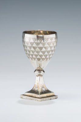 21. A SILVER KIDDUSH CUP IN RARE FORM. Ukraine, c. 1820. On a square base with knobbed stem 