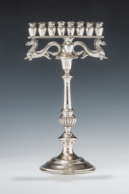 28. A RARE SILVER MENORAH. Vienna, c. 1880. On a bright cut candlestick base. Upper portion 