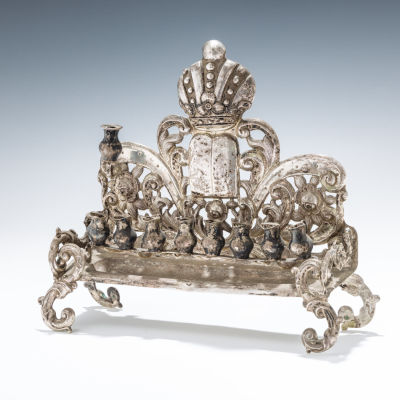 46. A SILVER HANUKKAH LAMP. Vienna, 1875. Bench form. Chased and cut backplate with floral and 