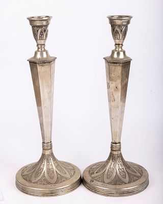 A MONUMENTAL PAIR OF SILVER SABBATH CANDLESTICKS. Austrian, c. 1900. On round bases chased with 