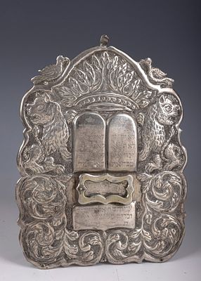 14. A SILVER TORAH SHIELD. Poland, 1907. Engraved, chased and tooled with two lions flanking an 