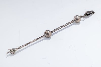 A SILVER TORAH POINTER. Poland, 18th century. The body of long twisted form that is separated 