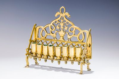 A BRASS HANUKKAH LAMP. Poland, 18th century. On four legs with eight large oil holders. The 