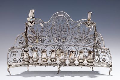 AN EARLY BAAL SHEM TOV FILIGREE HANUKKAH LAMP. Ukraine, c. 1820. On six legs. With eight oil 