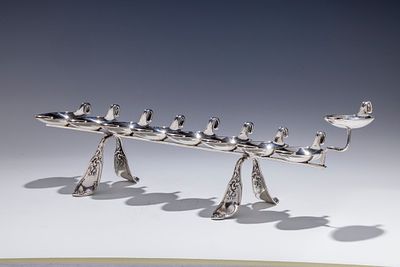 A LARGE SILVER HANUKKAH LAMP CRAFTED FROM SPOONS. Germany, c.1890. Hand crafted from large soup 