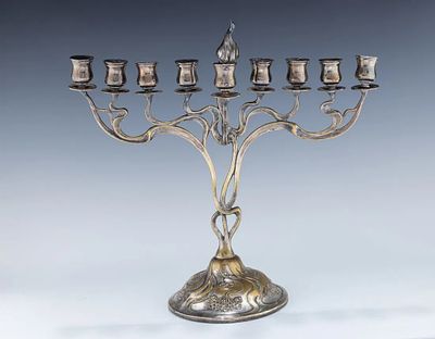 A RARE AND IMPORTANT ART NOUVEAU MENORAH. Germany, c. 1910. Possibly by WMF. On a round base