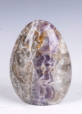 A POLISHED EGG FORM AMETHYST. Carved and polished to the form of an egg. 7" tall