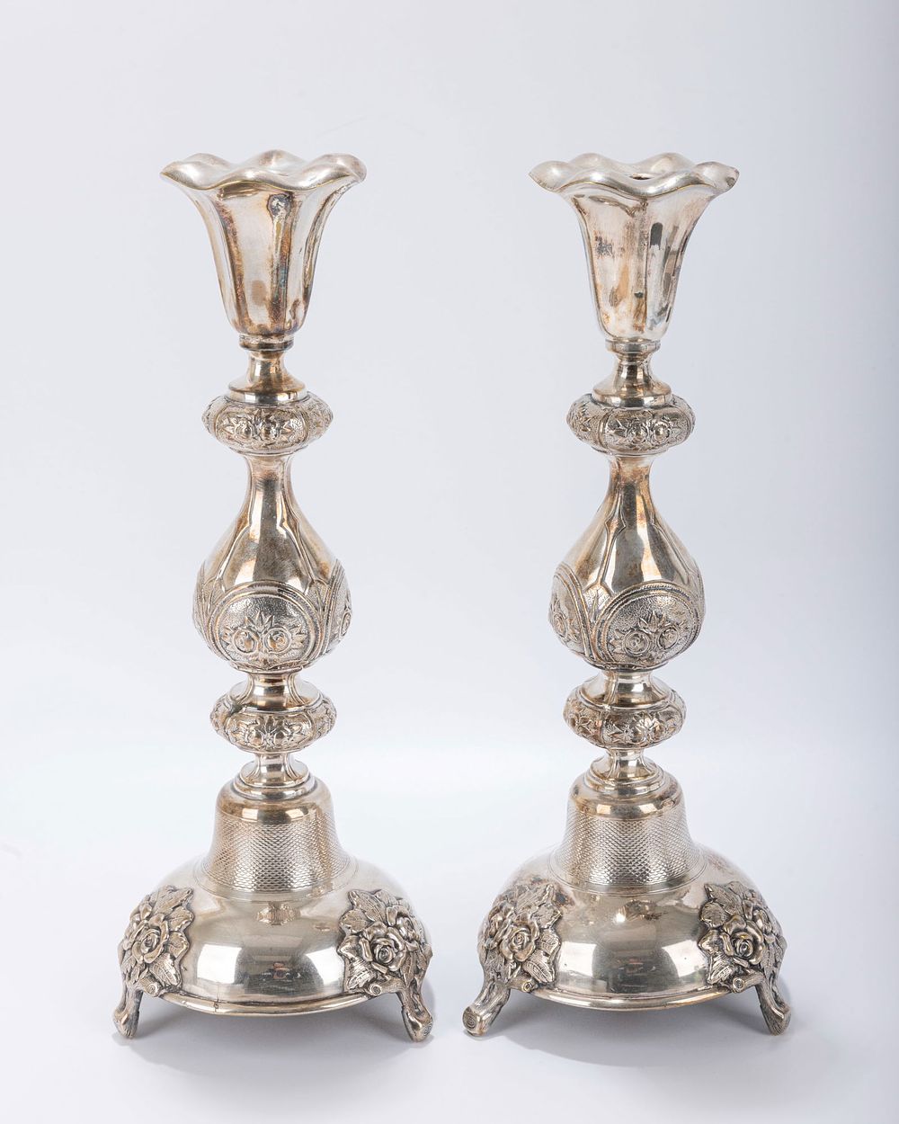A PAIR OF LARGE SABBATH CANDLESTICKS BY HANDELSMAN. Warsaw, Poland. On grapevine bases that are 