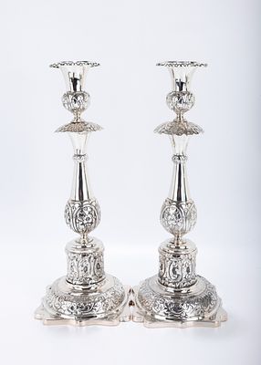 A PAIR OF EXCEPTIONAL SILVER SABBATH CANDLESTICKS Minsk, 1880. Each on a stylized square base,.