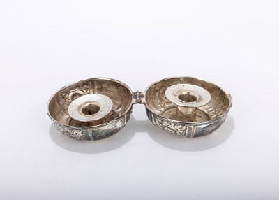 A STERLING SILVER TRAVELING SABBATH CANDLE HOLDER. American, c. 1990. In the shape of a yo-yo.
