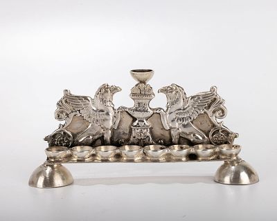 A MINIATURE SILVER HANUKKAH LAMP. Probably Israel, c. 1970. On domed supports with griffon 