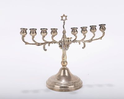 A SILVER HANUKKAH MENORAH. Probably Israel, c. 1980. On a round domed base with traditional 