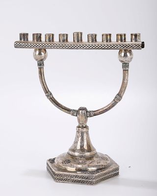A STERLING SILVER HANUKKAH MENORAH. Israel, 20th century. On a hexagonal base with two 