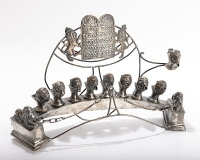 A LARGE ASSEMBLED SILVER HANUKKAH LAMP. Probably Germany, 20th century. On a curved base. With 