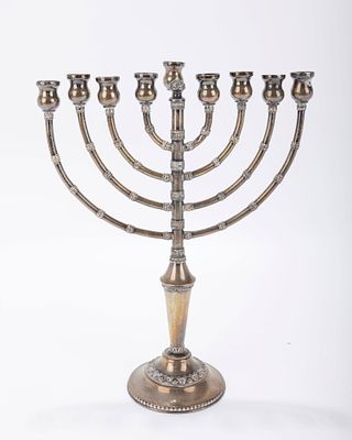 A STERLING SILVER HANUKKAH MENORAH. Israel, c. 1970. On a domed base. Decorated with filigree. 