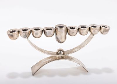 A SILVERPLATED HANUKKAH MENORAH. Probably Israel. Apparently unmarked. In modernist form. 12 