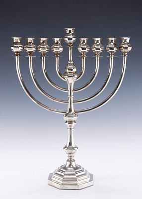 A STERLING SILVER HANUKKAH MENORAH BY TIFFANY AND COMPANY. New York c. 1990. On a six sided 