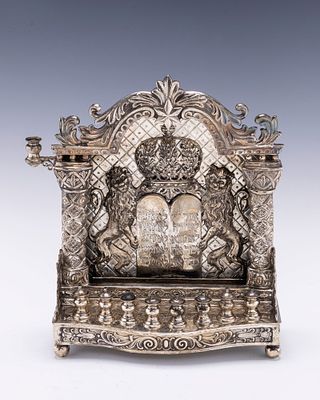 A SILVER HANUKKAH LAMP. Germany, c. 1900. On four spherical feet. With eight outwardly tapering 