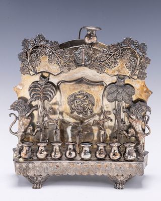 A PARCEL GILT SILVER HANUKKAH LAMP BY JAN POGORZELSKI. Warsaw, 1861. On four hand crafted feet. 