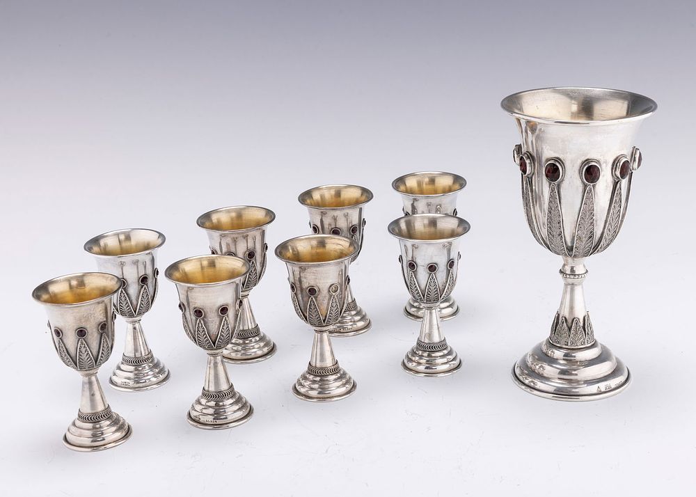 A LARGE STERLING SILVER KIDDUSH CUP WITH EIGHT SMALLER CUPS BY YEMINI SILVERSMITHS. Jerusalem 