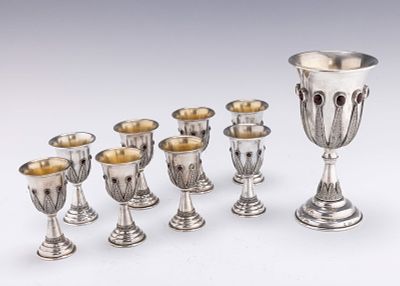 A LARGE STERLING SILVER KIDDUSH CUP WITH EIGHT SMALLER CUPS BY YEMINI SILVERSMITHS. Jerusalem 
