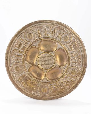 A BRASS SEDER DISH BY BEZALEL. Jerusalem, c. 1930 Stamped with Zev Raban designs. 13" wide