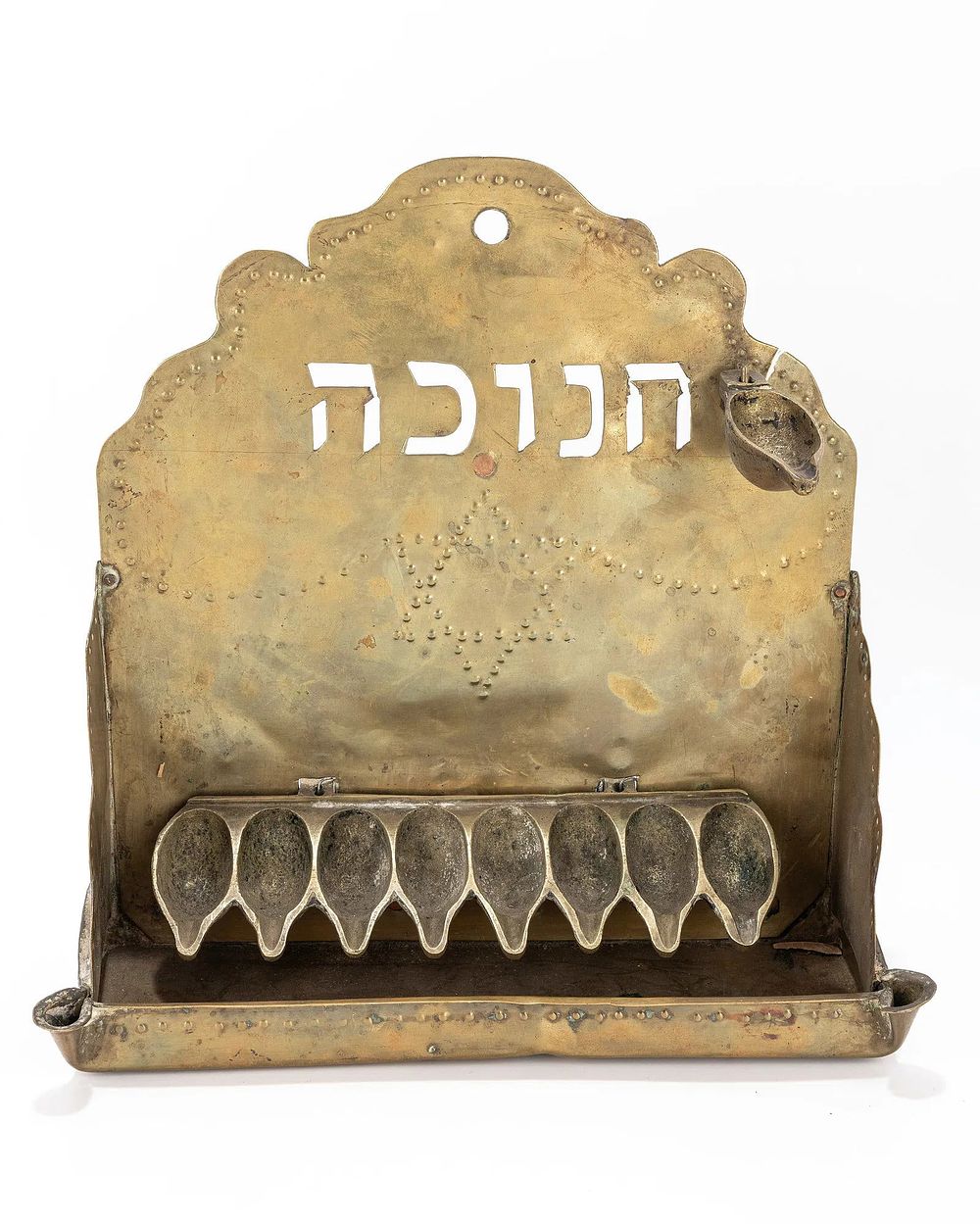 A BRASS HANUKKAH LAMP. The Netherlands, c. 1920. Hand chased and cut brass sheet metal 