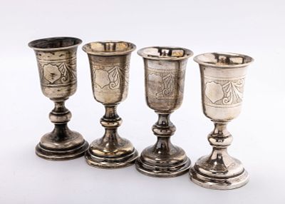 A GROUP OF FOUR SILVER KIDDUSH GOBLETS. Warsaw, c. 1880. Each on a round base with engraved 