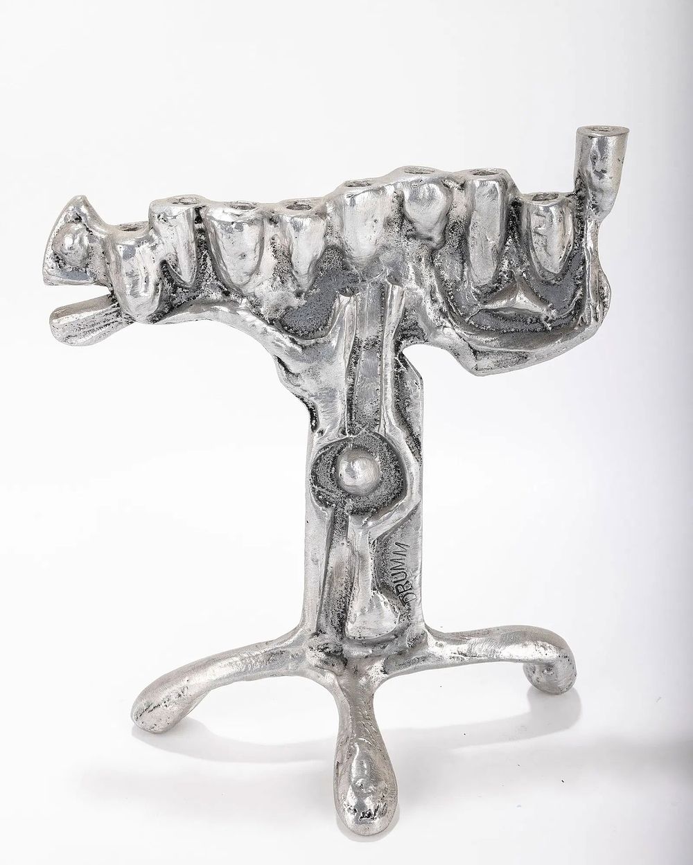 AN ALUMINUM MENORAH SCULPTURE BY DON DRUMM (American, b. 1935). A ALUMINUM MENORAH SCULPTURE BY 