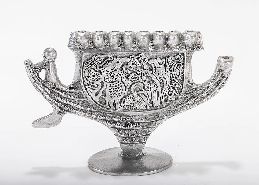 A ALUMINUM MENORAH SCULPTURE BY DON DRUMM (American, b. 1935). With an ark shaped base,. A 
