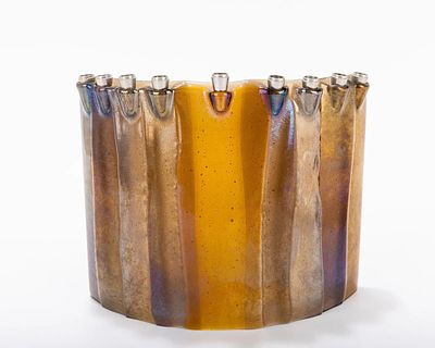 A CARNIVAL GLASS MENORAH by GLASSLIGHT STUDIO. American 2006. In a semi-circle form, made of 