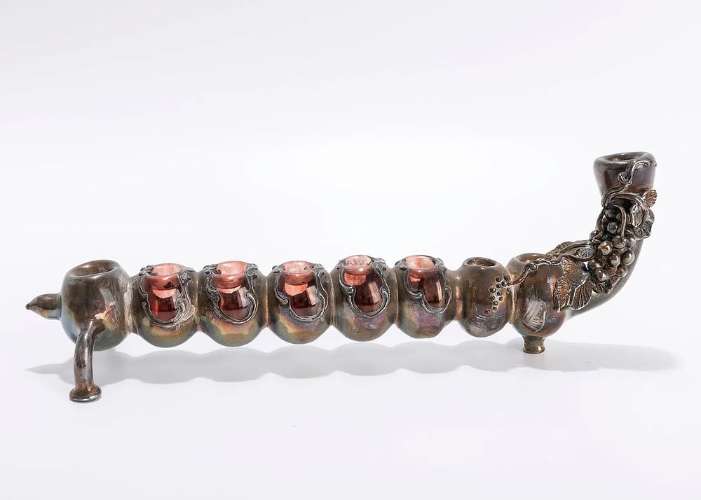 A SILVER OVERLAY HANUKKAH LAMP. Israel, modern. Made of light silver on glass. 10 inches wide.